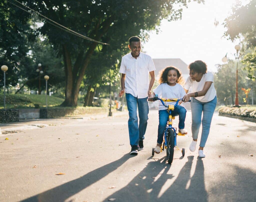 family bonding and teaching child to ride a bike